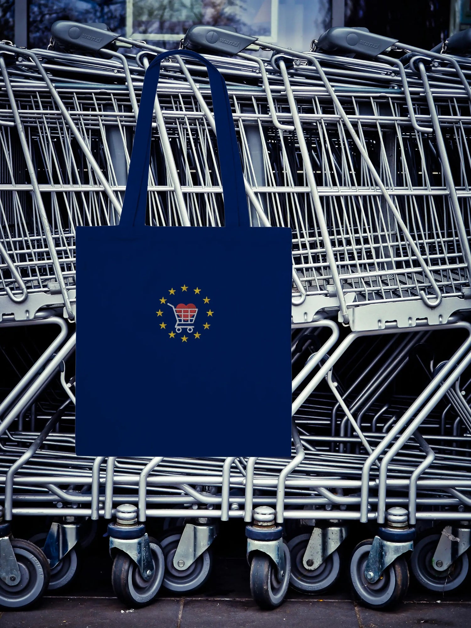 Navy Blue "Buy from EU" tote bag on top of a stack of shopping carts